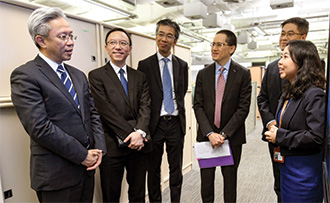 Mr Law (first left) visited the Office of the Government Chief Information Officer.