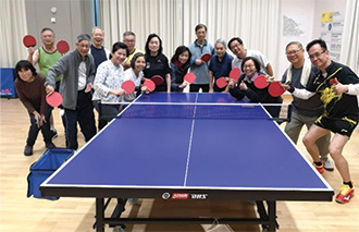 Ms Hui (third right) enjoys playing ping pong with her friends after retirement.