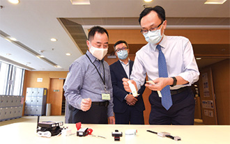 Mr Nip (right) visited the monitoring centre of the Office of the Government Chief Information Officer to learn more about the use of the multi-tech approach in monitoring persons under home quarantine.