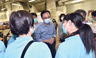 Mr Nip (centre) visited Camp Street Refuse Collection Point in Sham Shui Po to learn more about the work of the frontline cleansing workers.