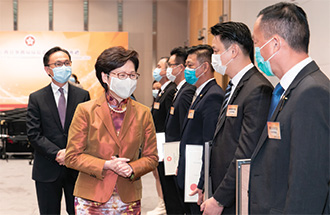 Mrs Lam (second left) and Mr Nip (first left) shared the joy of the award recipients.