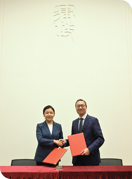 Mr Paul Lam (right) signed record of meeting with the Minister of Justice, Ms He Rong, to deepen exchanges and co-operation on talent nurturing and legal services.