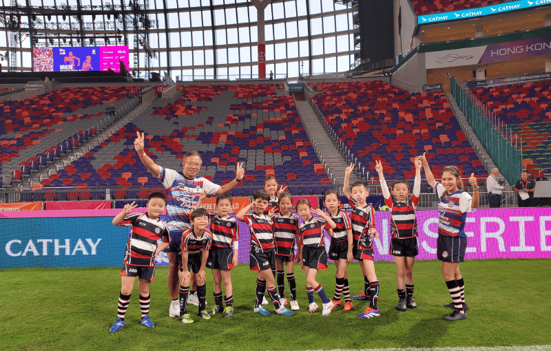 Mr Wong (second left) has strived to promote “touch rugby”, hoping that students can develop team spirit through learning this type of sports and social interaction can also be promoted.