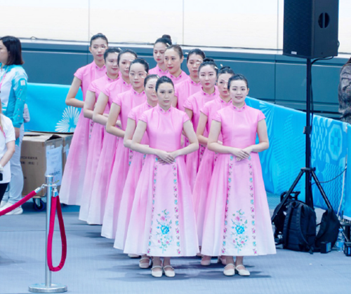 Volunteers serving as ceremony assistants strived for excellence during training sessions by repeatedly rehearsing standard gestures for holding medal trays.  Perfection was pursued in every detail in the hope of presenting medals to athletes with cordial smiles and proper decorum.  