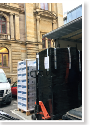 Unloading pallets of surgical face masks at office entrance HKETO Berlin